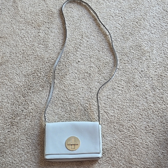 kate spade Handbags - Stylish White Crossbody Bag with Gold Accent